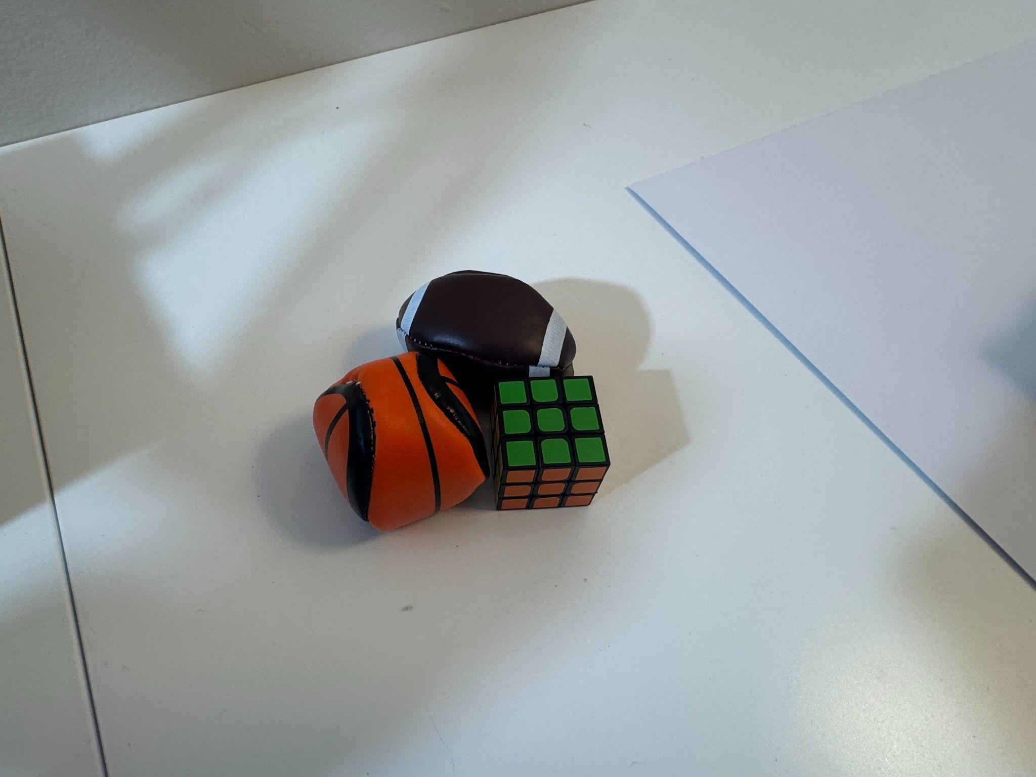 Basketball, American football, and Rubik's cube used as familiar objects